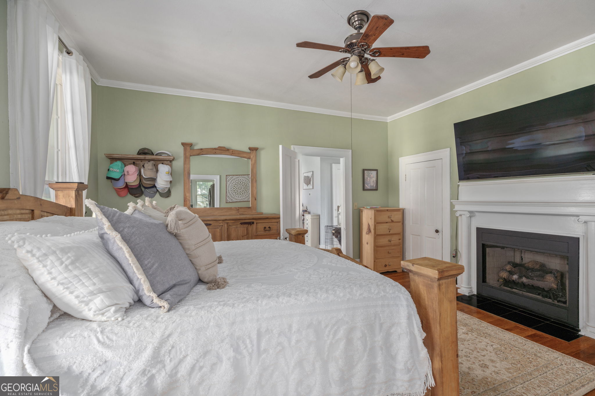 7890 Poplar Springs Road Byromville, GA 31007 - Photo 25 of 74 a spacious bedroom with a bed a fireplace and a flat screen tv