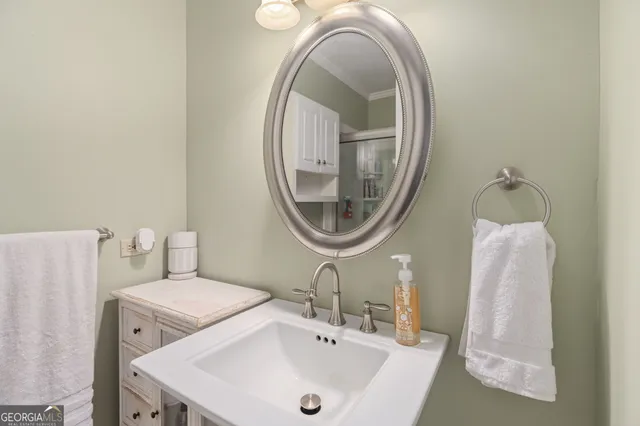 a front view of a house with a garden and trees