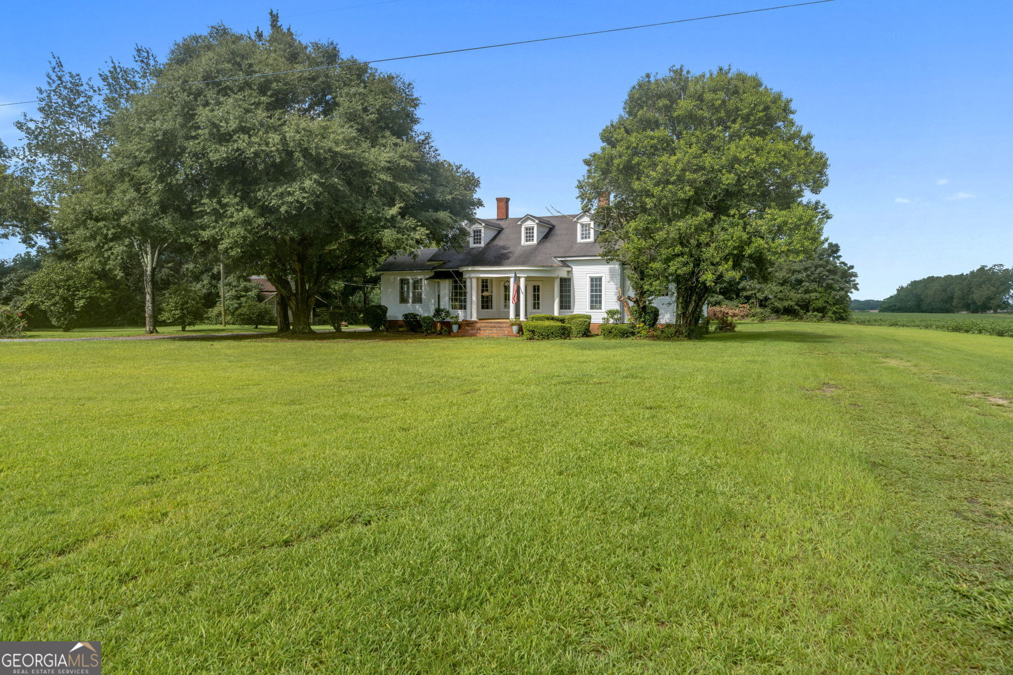 7890 Poplar Springs Road Byromville, GA 31007 - Photo 3 of 74 a front view of a house with a garden