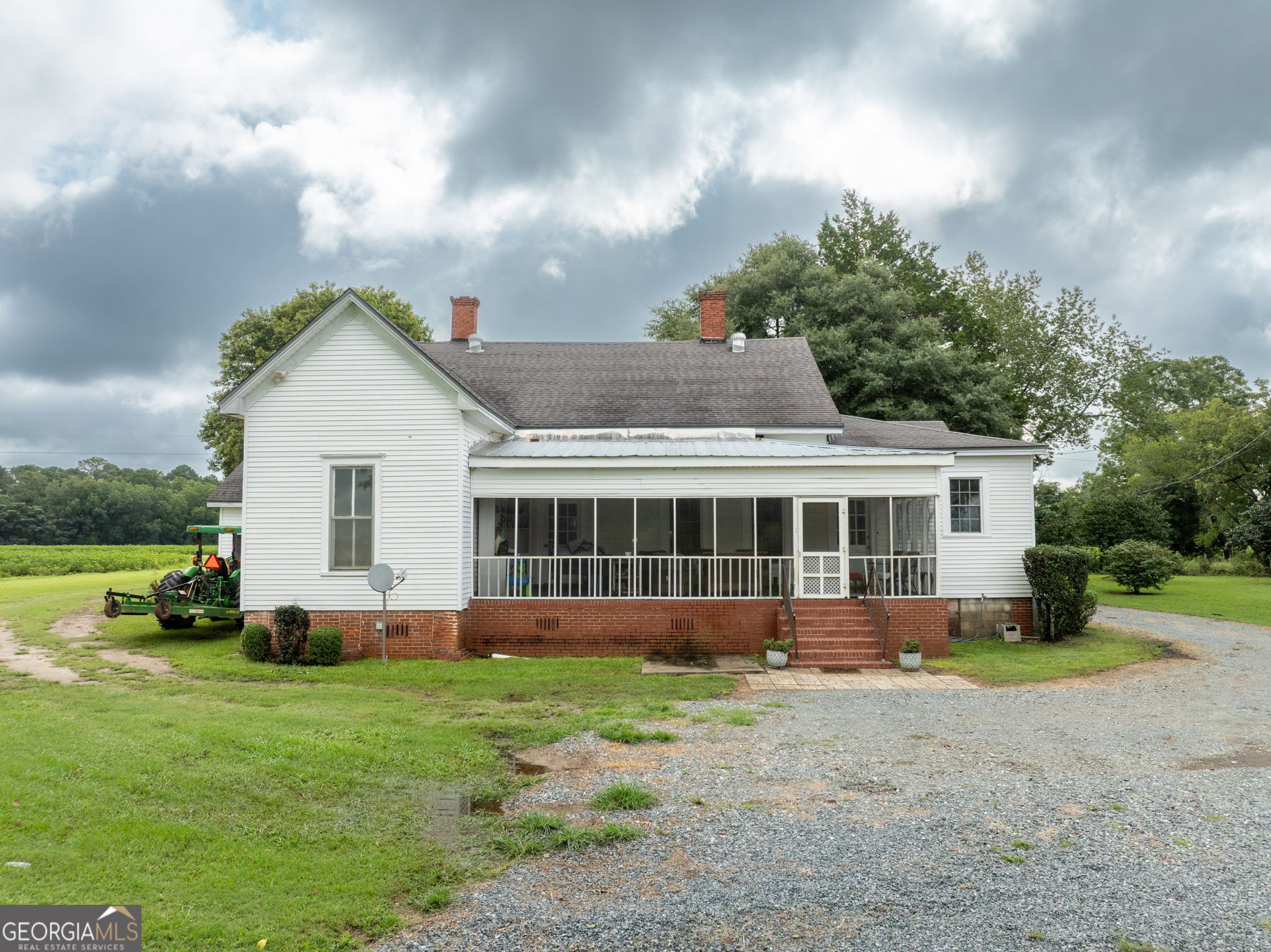 7890 Poplar Springs Road Byromville, GA 31007 - Photo 35 of 74 a front view of a house with a garden and yard