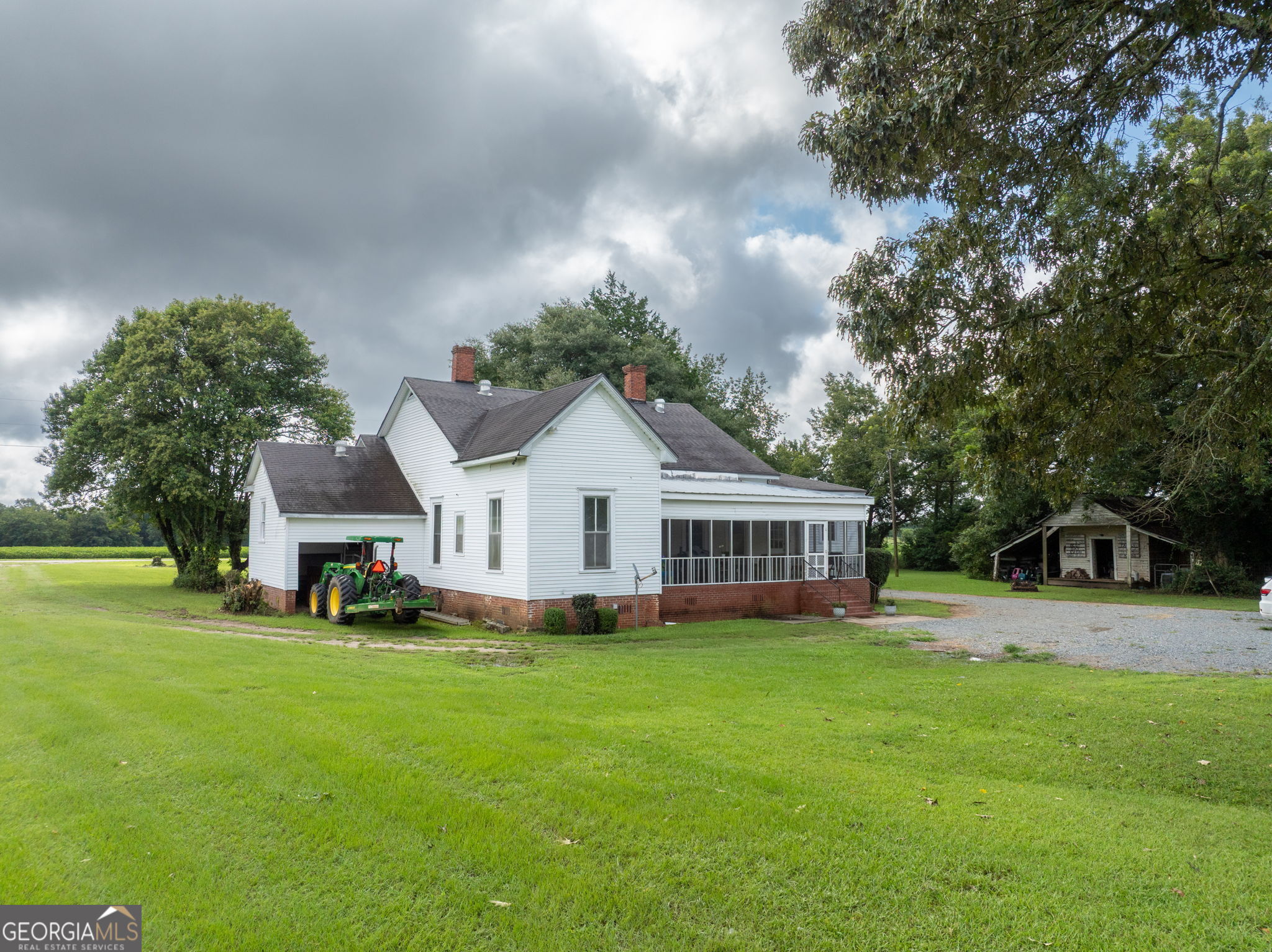 7890 Poplar Springs Road Byromville, GA 31007 - Photo 37 of 74 a front view of a house with a garden and trees