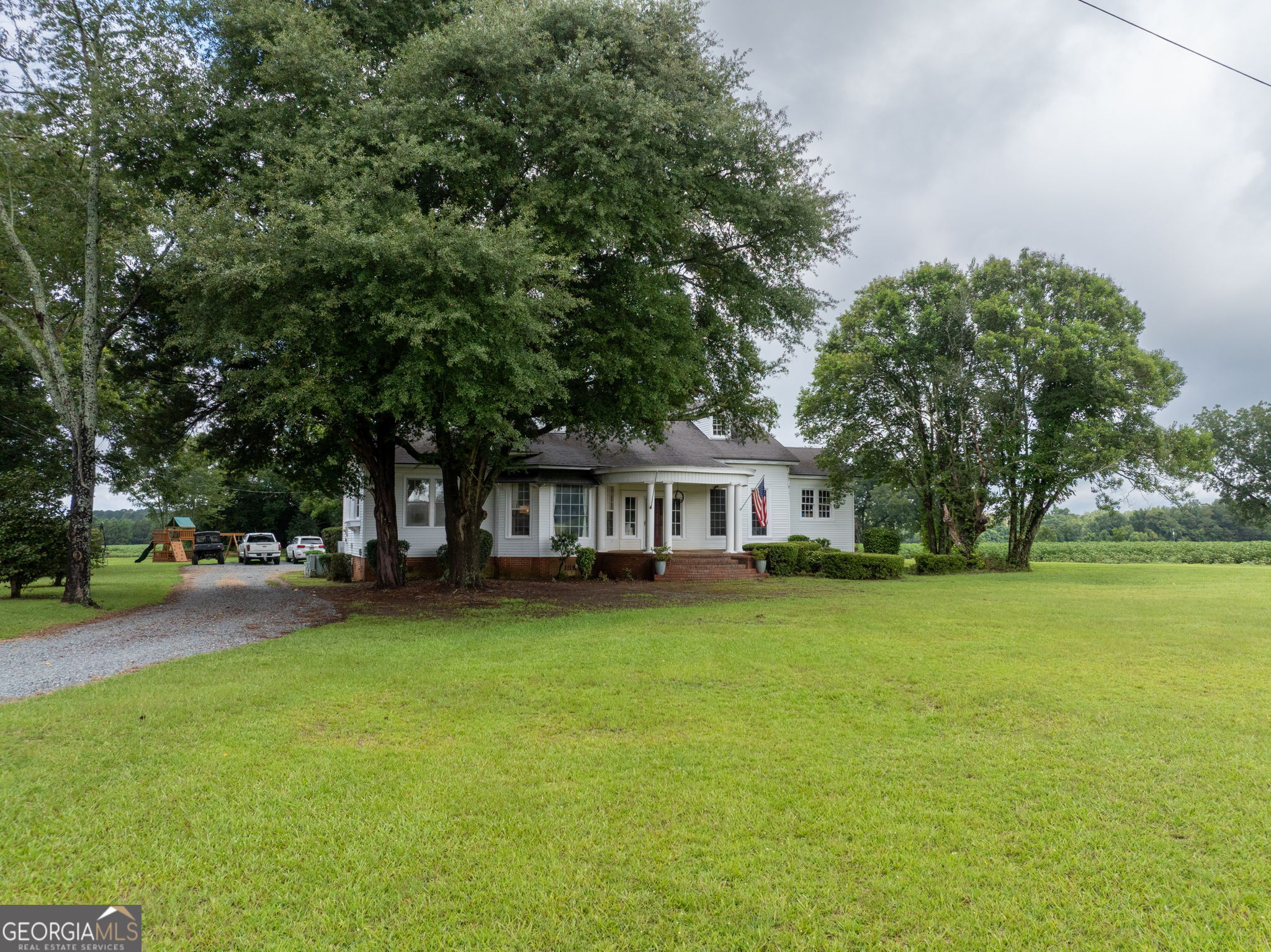 7890 Poplar Springs Road Byromville, GA 31007 - Photo 4 of 74 a view of a house with a big yard and large trees