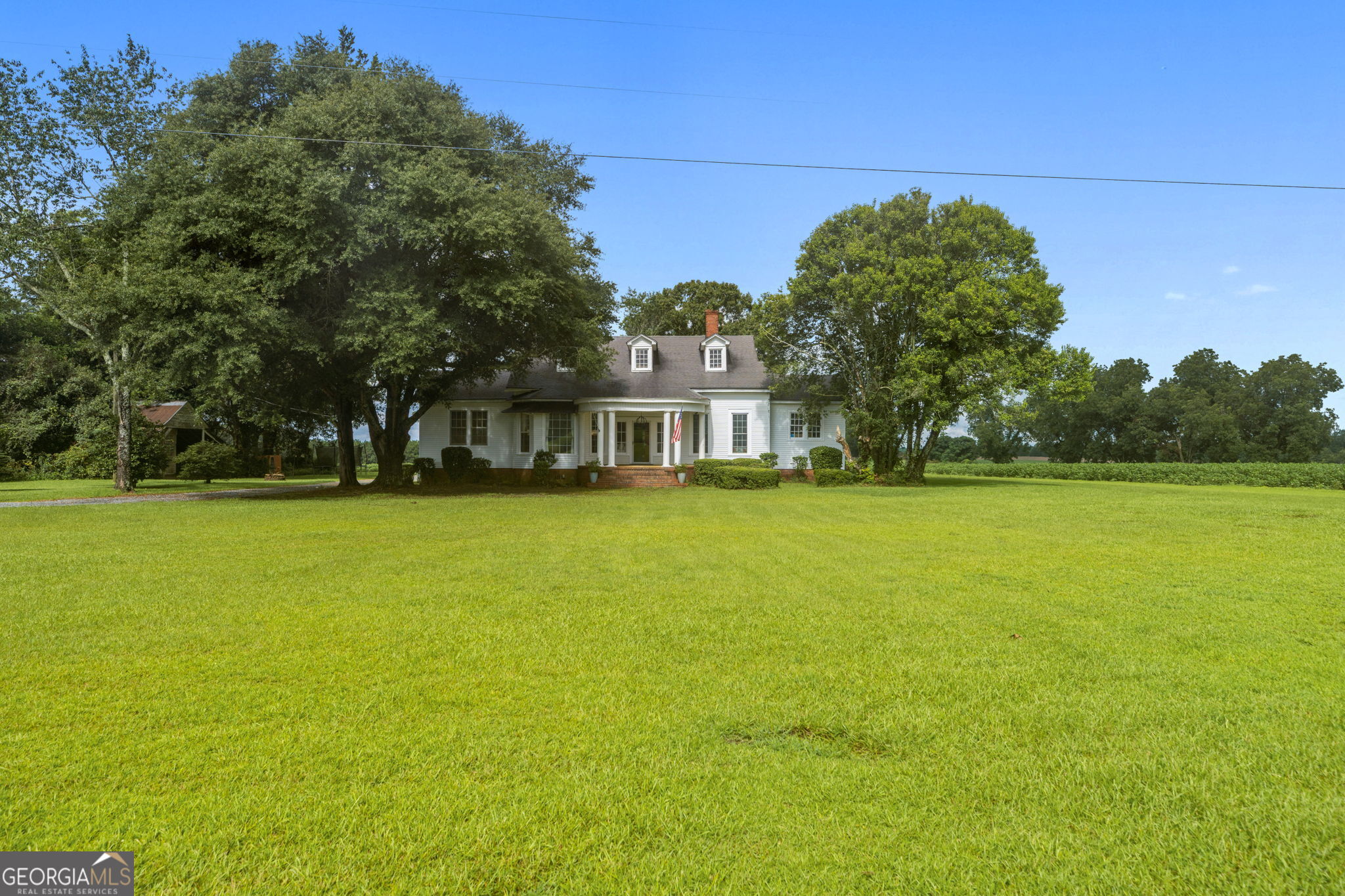 7890 Poplar Springs Road Byromville, GA 31007 - Photo 5 of 74 a house view with swimming pool in front of it