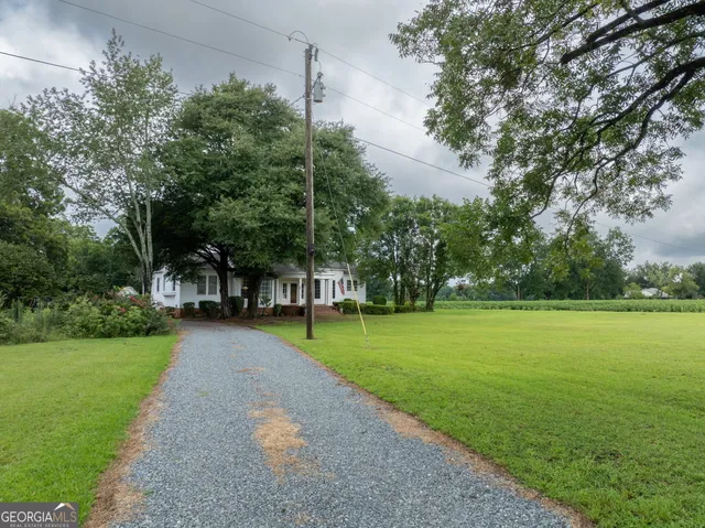 a living room with fireplace furniture and a large window