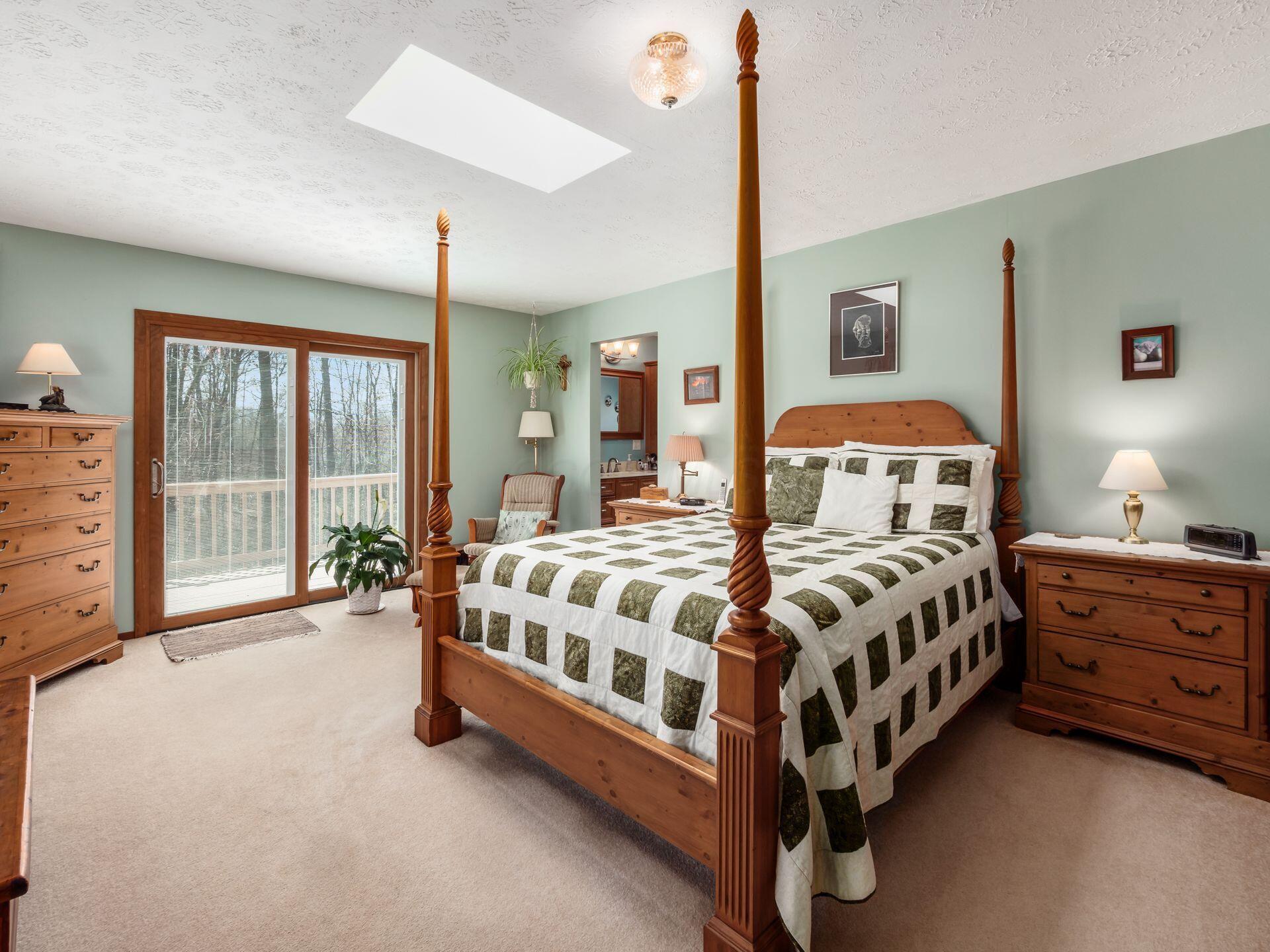 12741 Goodman Road Ashville, OH 43103 - Photo 19 of 61 The spacious primary bedroom includes sliding glass doors leading to private deck