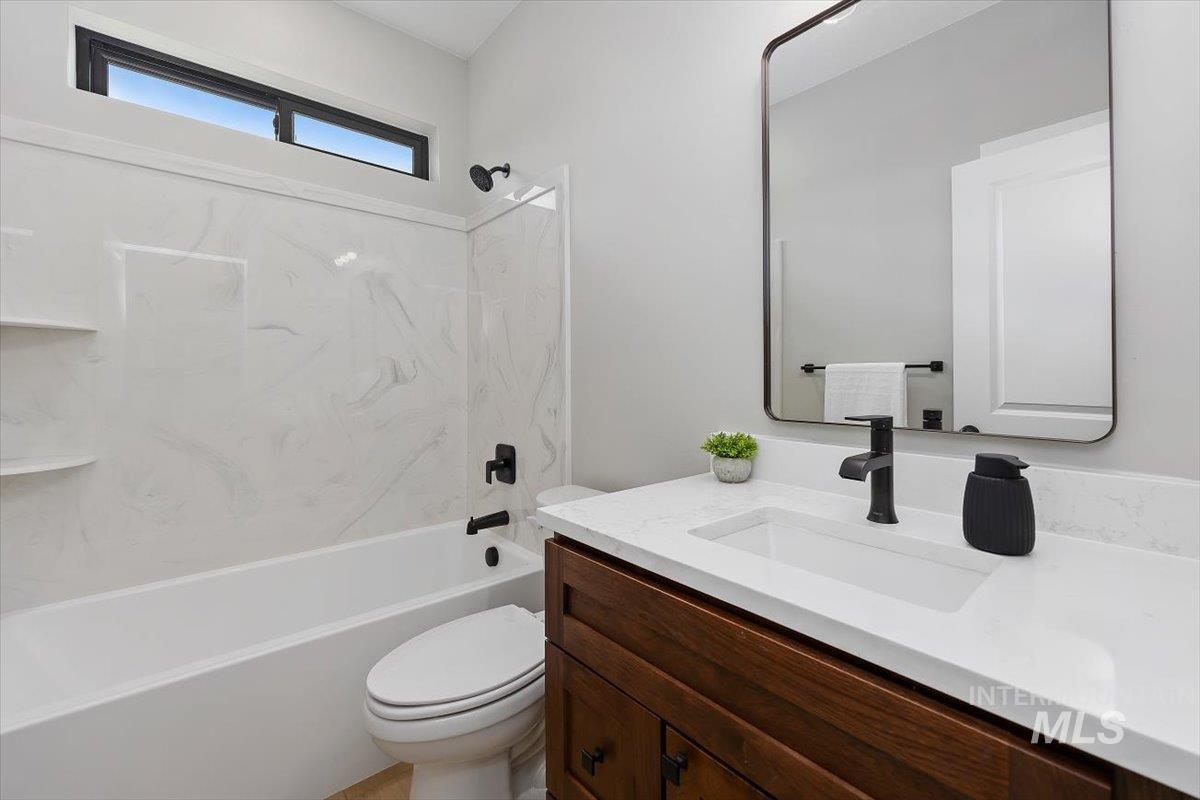 1201 Jade Drive Rupert, ID 83350 - Photo 21 of 27 Bathroom featuring a dark wood-finish vanity with a white countertop and integrated sink