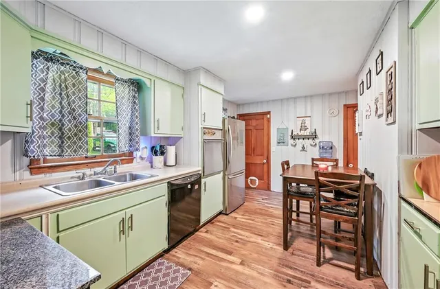 a kitchen with a sink appliances and cabinets