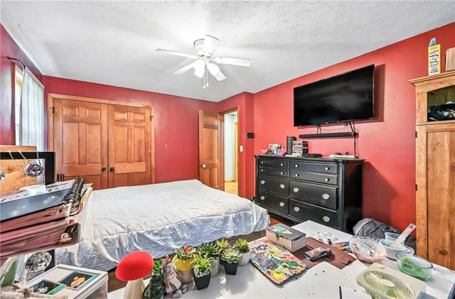 a bedroom with a bed and flat screen tv