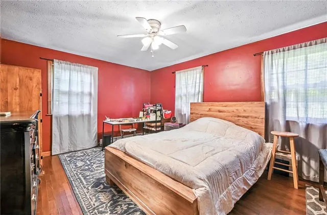 a bedroom with a large bed and a chandelier