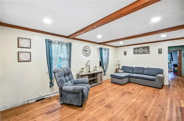 a living room with furniture and wooden floor