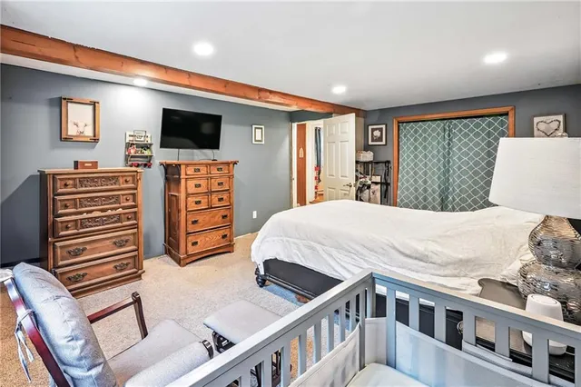 a bedroom with a bed and flat screen tv