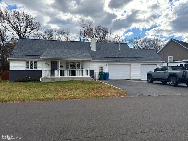 a front view of a house with a garden and balcony