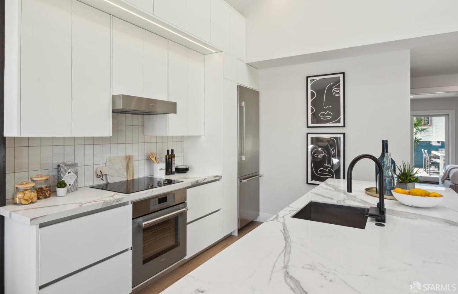 674 Capp Street San Francisco, CA 94110 - Photo 12 of 41 a kitchen with a sink a stove and cabinets