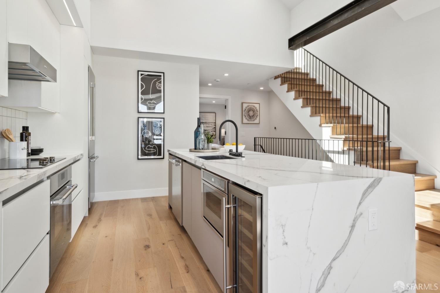 674 Capp Street San Francisco, CA 94110 - Photo 13 of 41 a kitchen that has a sink and a stove in it