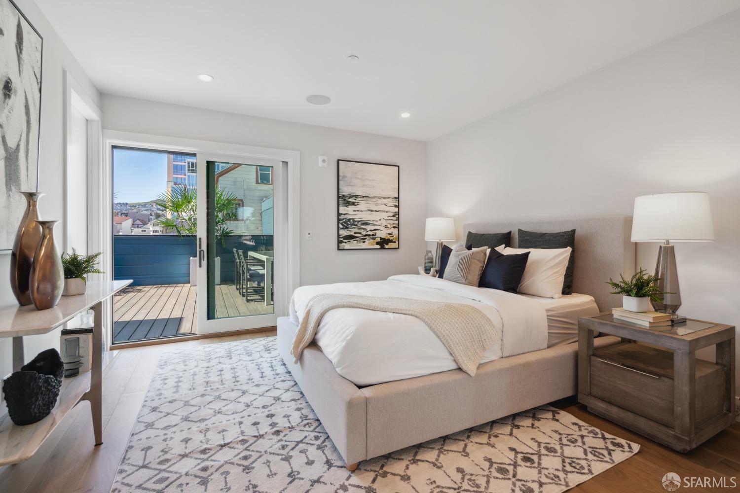 674 Capp Street San Francisco, CA 94110 - Photo 15 of 41 a bedroom with a large bed and a rug