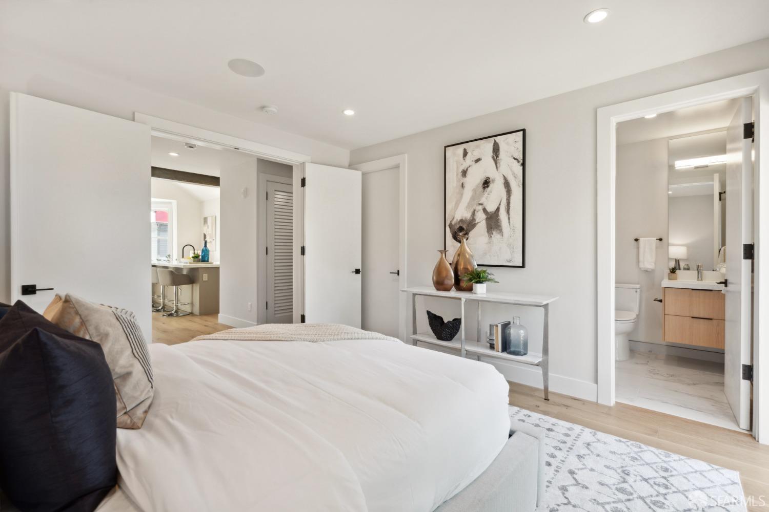 674 Capp Street San Francisco, CA 94110 - Photo 16 of 41 a bedroom with a large bed and a mirror