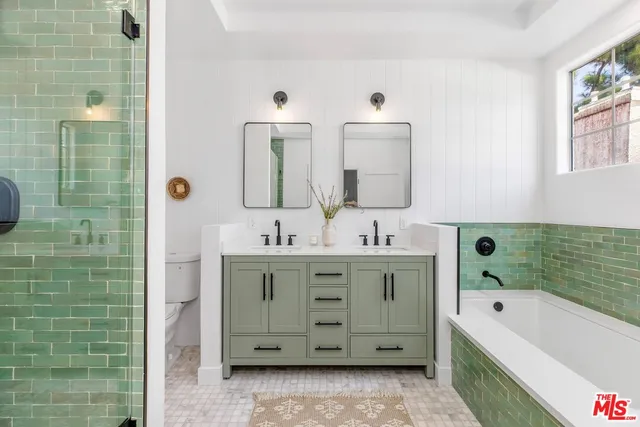 a bathroom with a bathtub sink and mirror