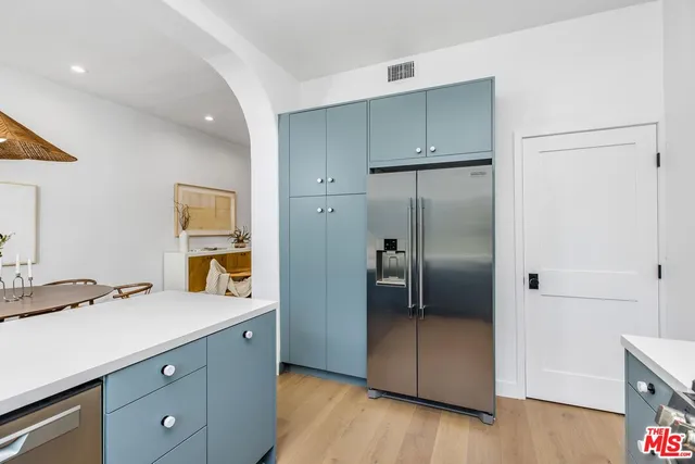 a kitchen with a refrigerator and a sink