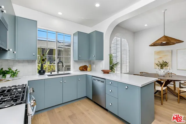 a kitchen with a sink stove and cabinets