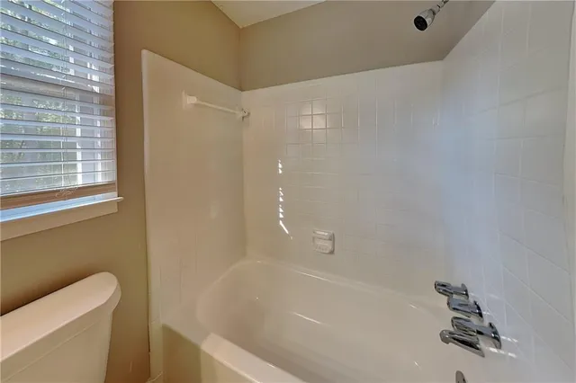 a bathroom with a bathtub and a toilet