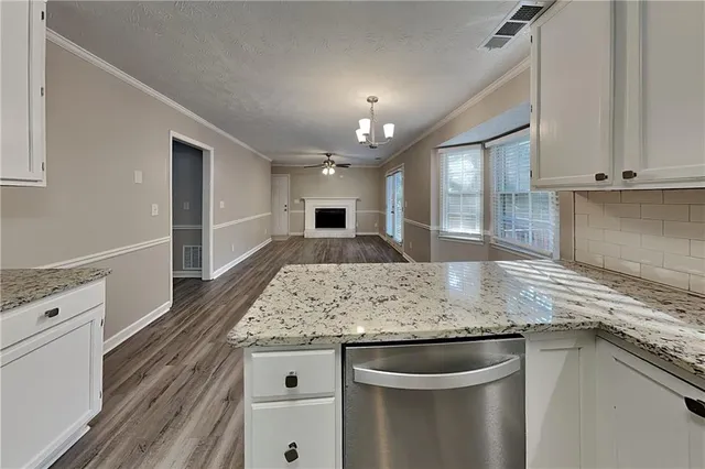 a kitchen with kitchen island granite countertop a sink and stove