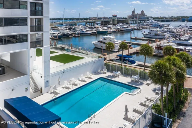 a living room with furniture kitchen view and a large window