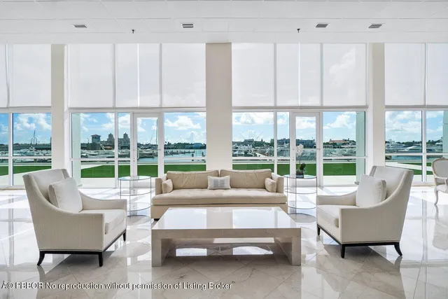 a living room with lots of furniture and a large window
