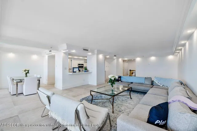 a living room with furniture and view of kitchen