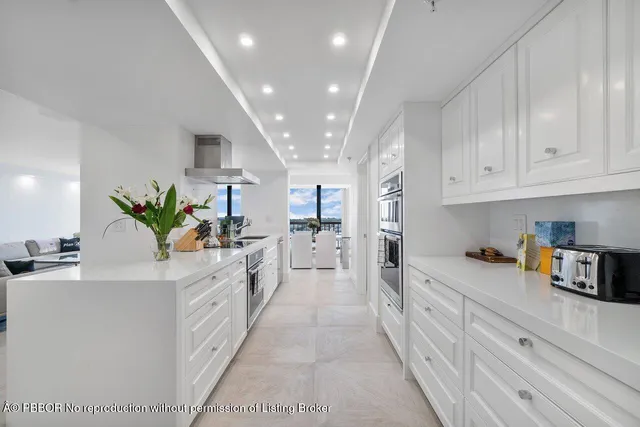 a kitchen with white cabinets and sink