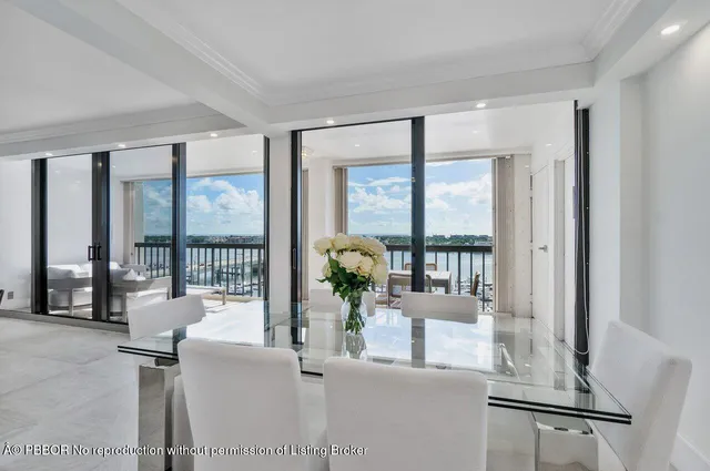 a living room with furniture and large windows