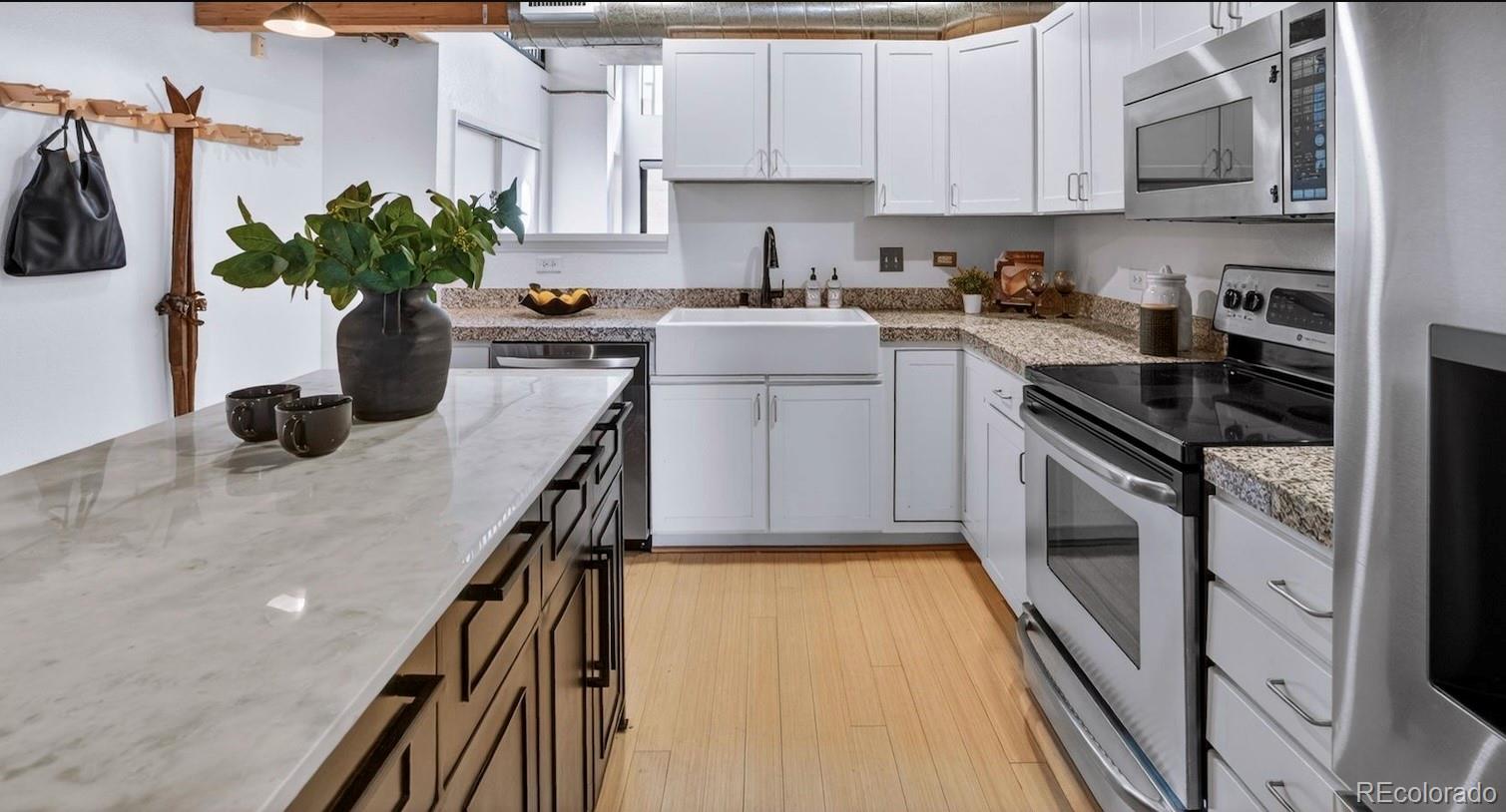 3225 Blake Street, Unit 20 Denver, CO 80205 - Photo 8 of 47 a kitchen with a sink appliances and cabinets