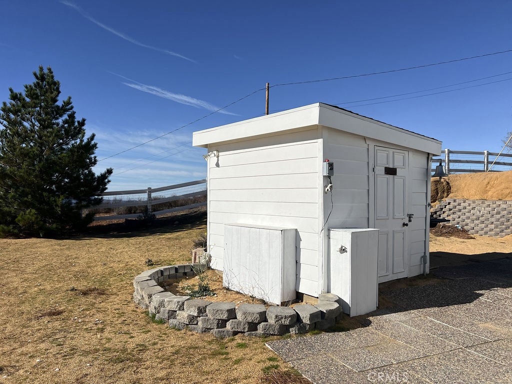 48565 Forest Springs Road Aguanga, CA 92536 - Photo 22 of 24 a view of a house with a wooden fence