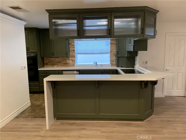 a kitchen with granite countertop a refrigerator and a sink