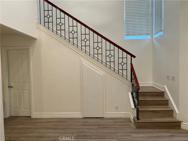 a view of empty room with wooden floor and fireplace
