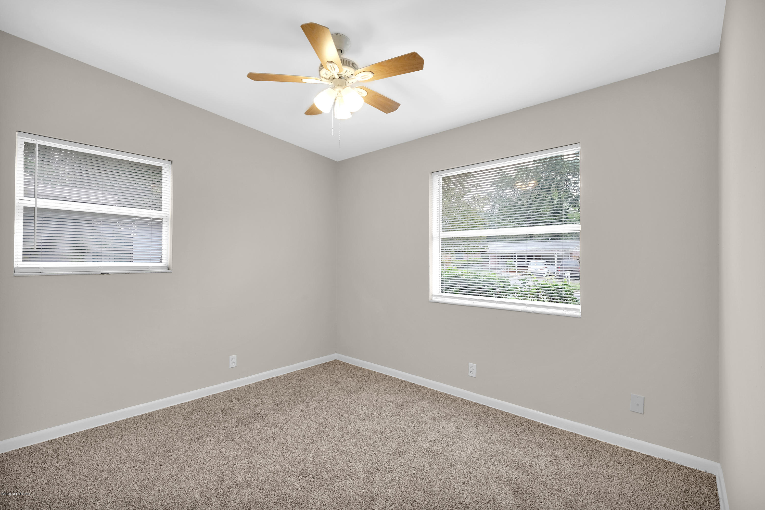 7504 Proxima Road Jacksonville, FL 32210 - Photo 18 of 24 an empty room with a window and a ceiling fan