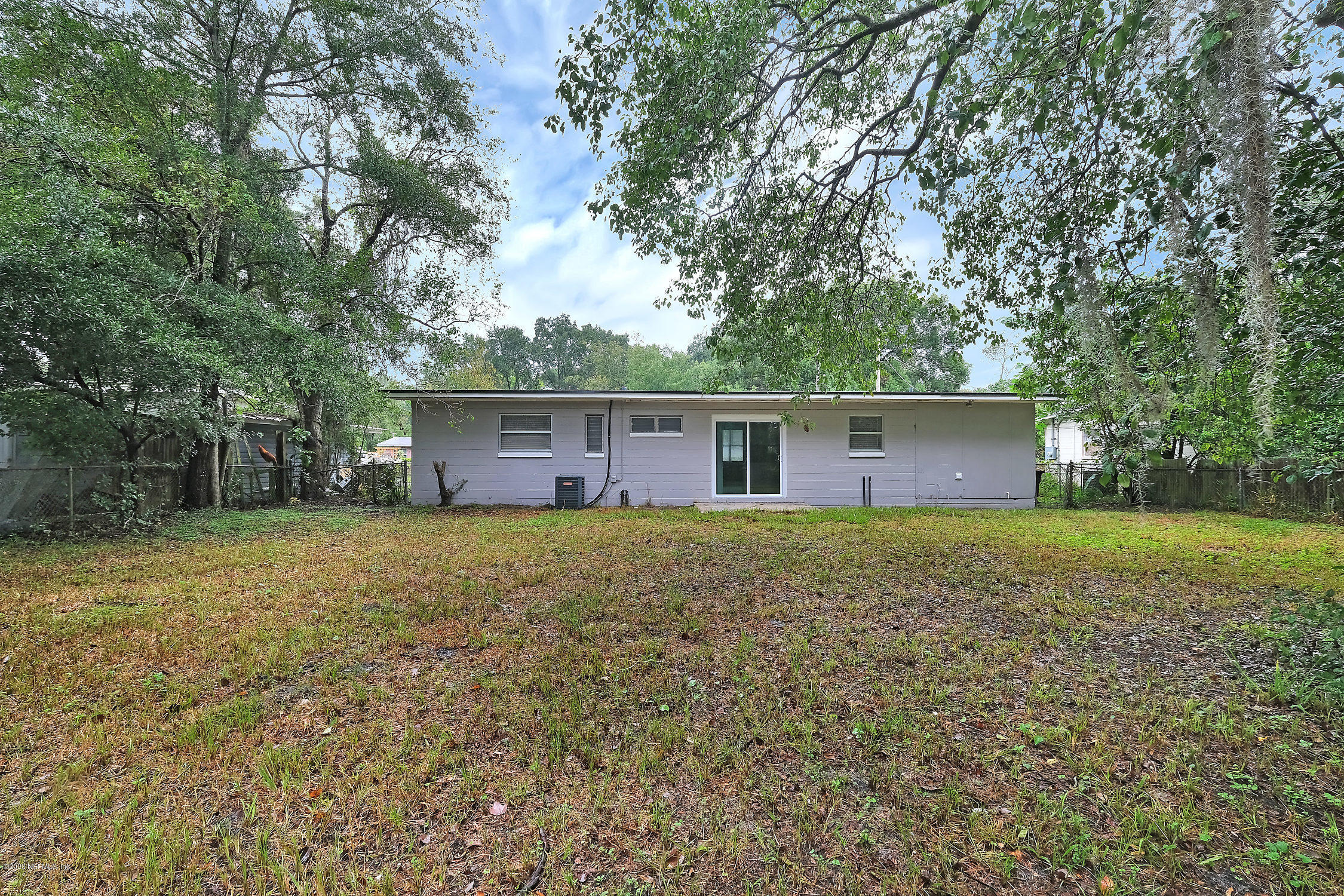 7504 Proxima Road Jacksonville, FL 32210 - Photo 23 of 24 a view of a yard with a house and trees