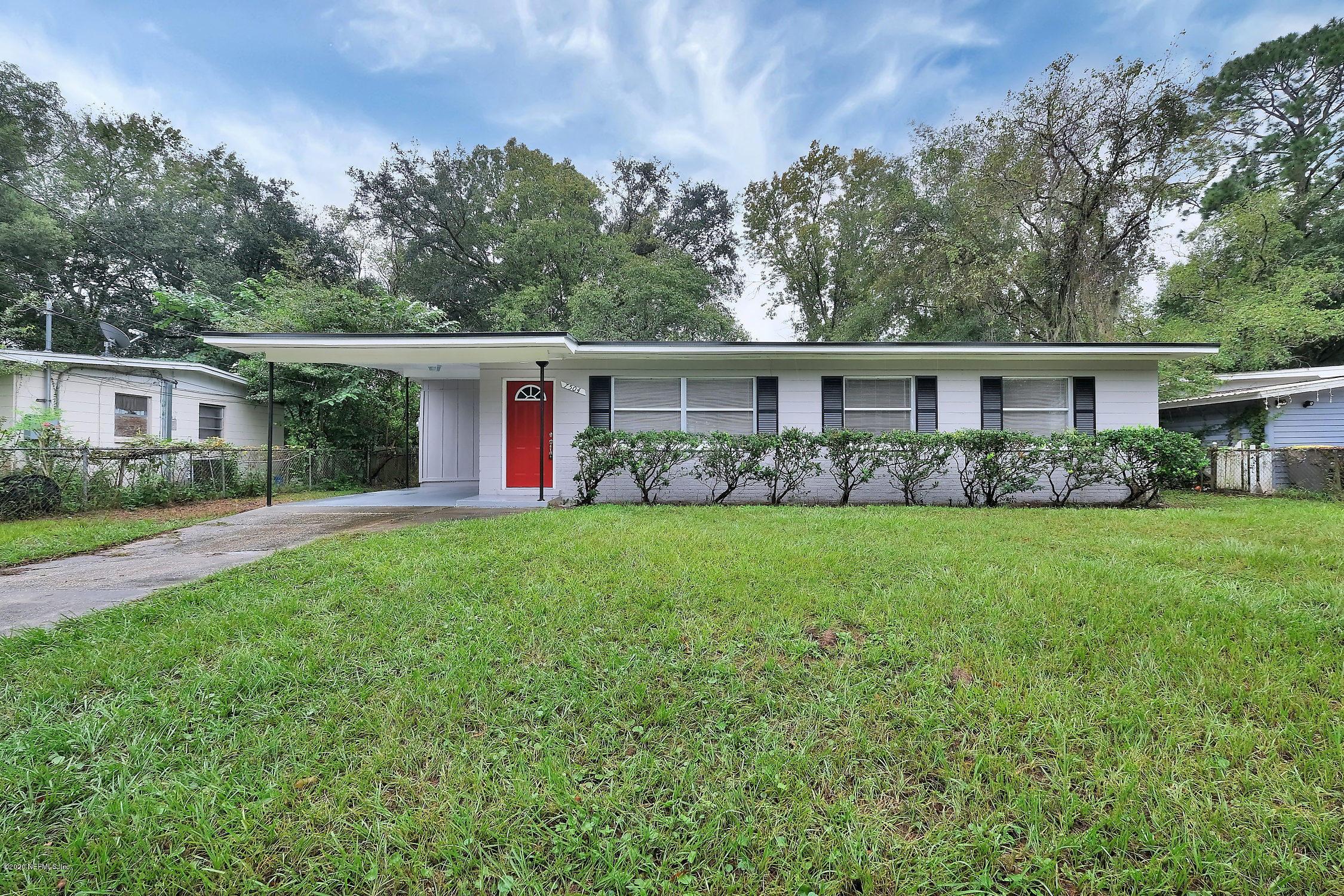 7504 Proxima Road Jacksonville, FL 32210 - Photo 3 of 24 a front view of house with yard and green space