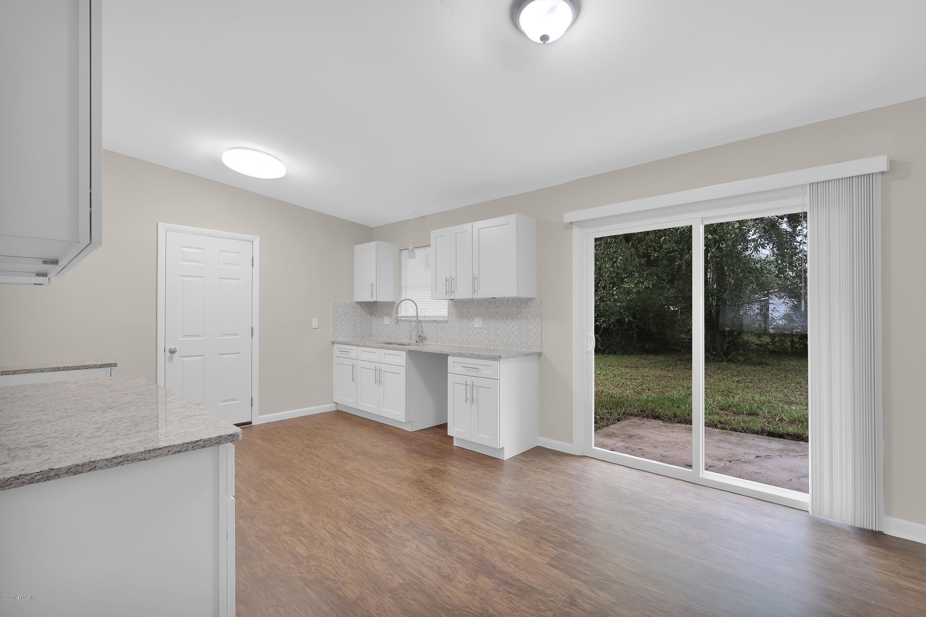 7504 Proxima Road Jacksonville, FL 32210 - Photo 8 of 24 a view of a kitchen with white cabinets and a sink