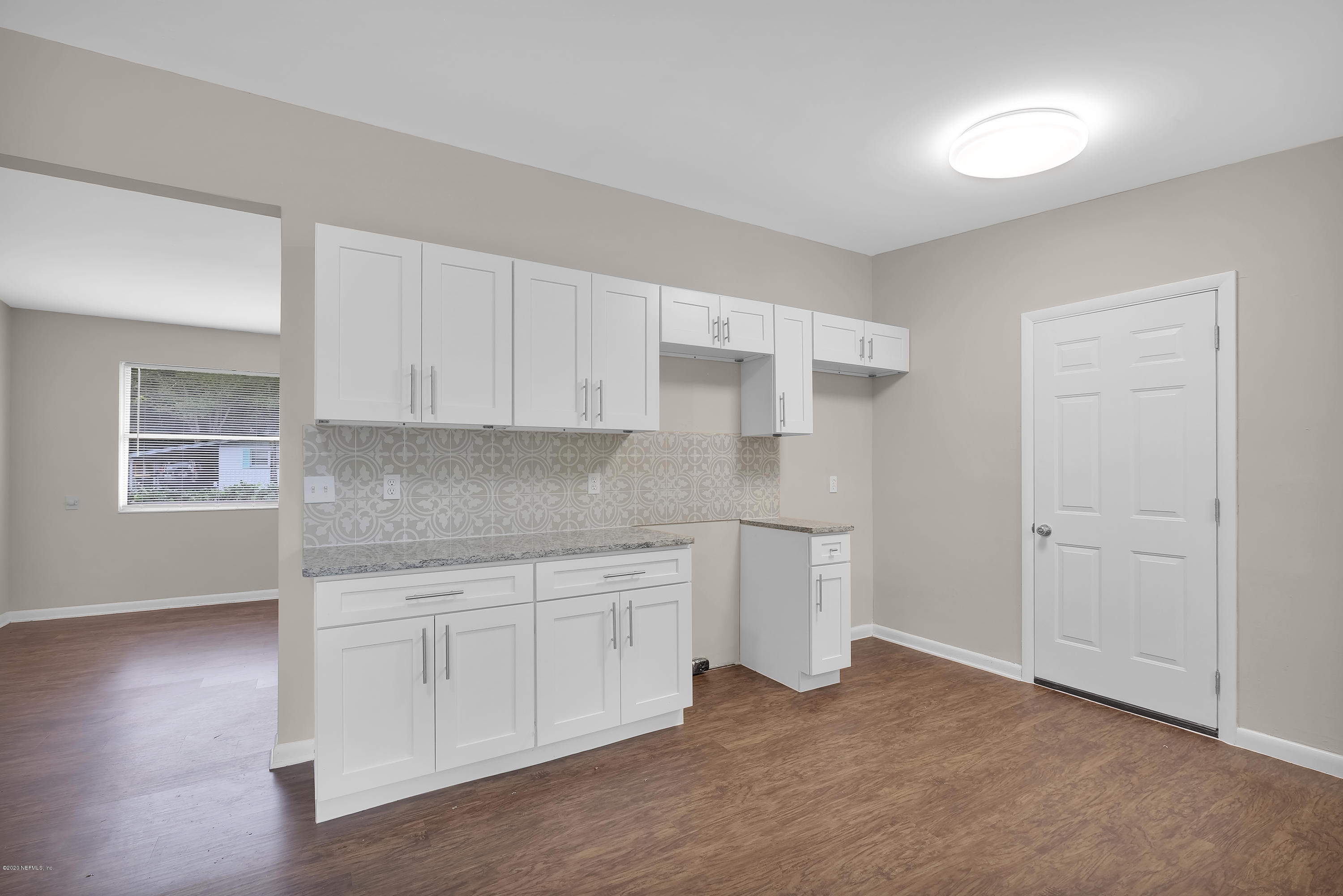 7504 Proxima Road Jacksonville, FL 32210 - Photo 10 of 24 a kitchen with white cabinets and sink