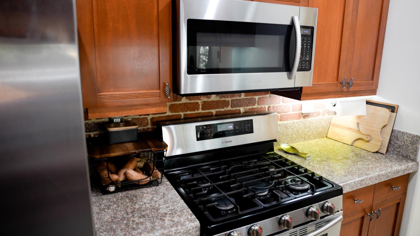30 East Julian Street, Unit 307 San Jose, CA 95112 - Photo 13 of 24 a kitchen with a stove and a microwave