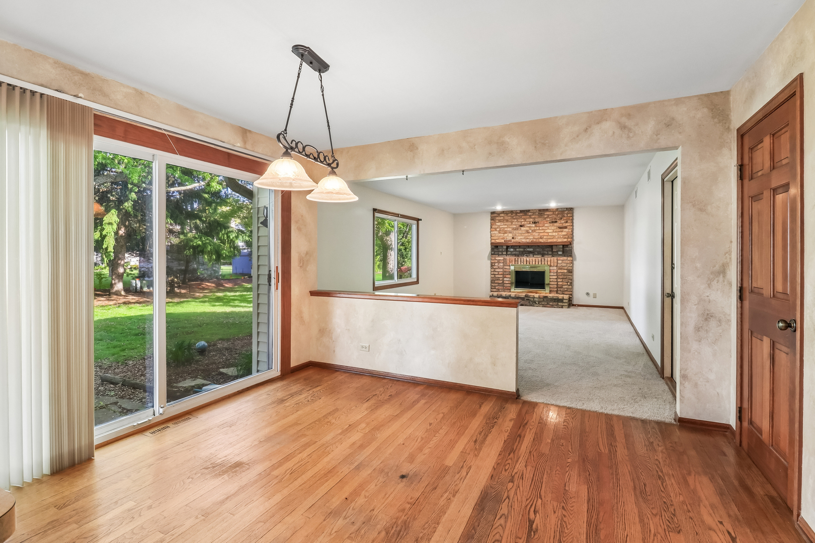 733 Buttonwood Circle Naperville, IL 60540 - Photo 7 of 39 a view of a room with wooden floor and windows