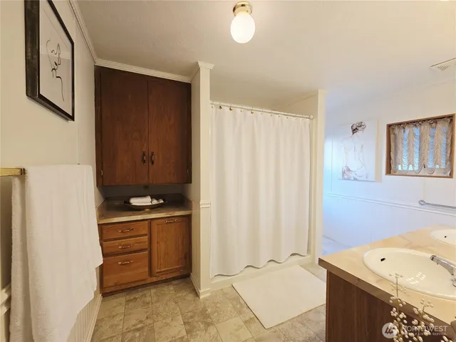 a bathroom with a tub sink and mirror