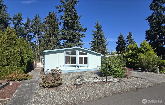 a white house that has a tree in front of it