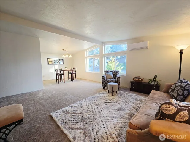 a living room with furniture rug and window