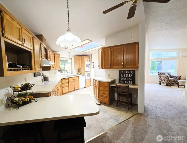 a large kitchen with a table chairs refrigerator and a sink