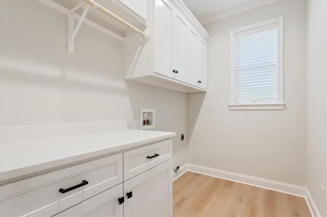 a room with a white cabinets and a wooden floor