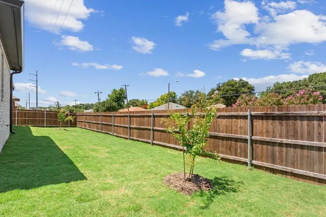 a view of a backyard with grass
