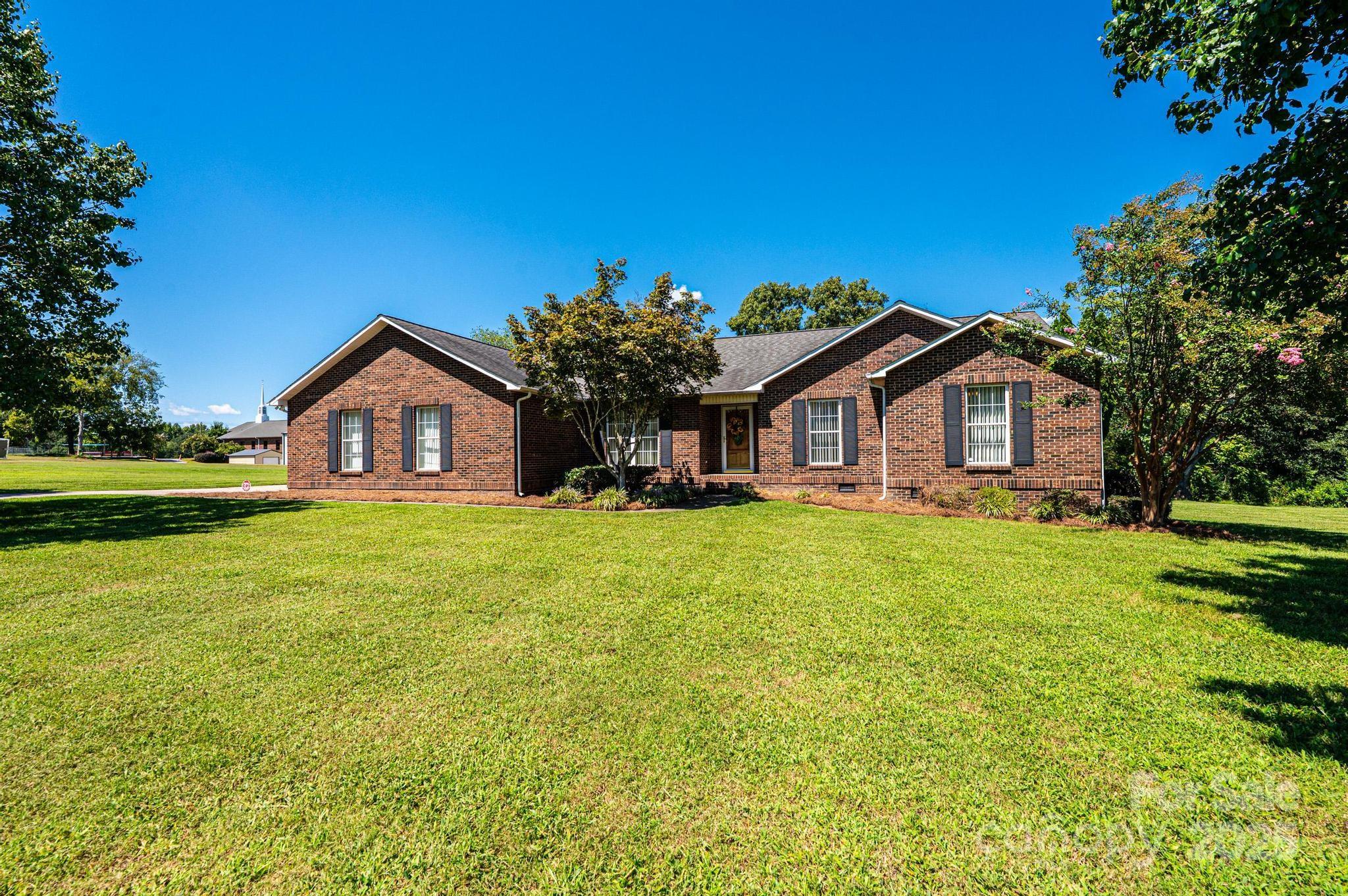 227 Robert Keever Road Stanley, NC 28164 - Photo 1 of 45 a front view of a house with garden