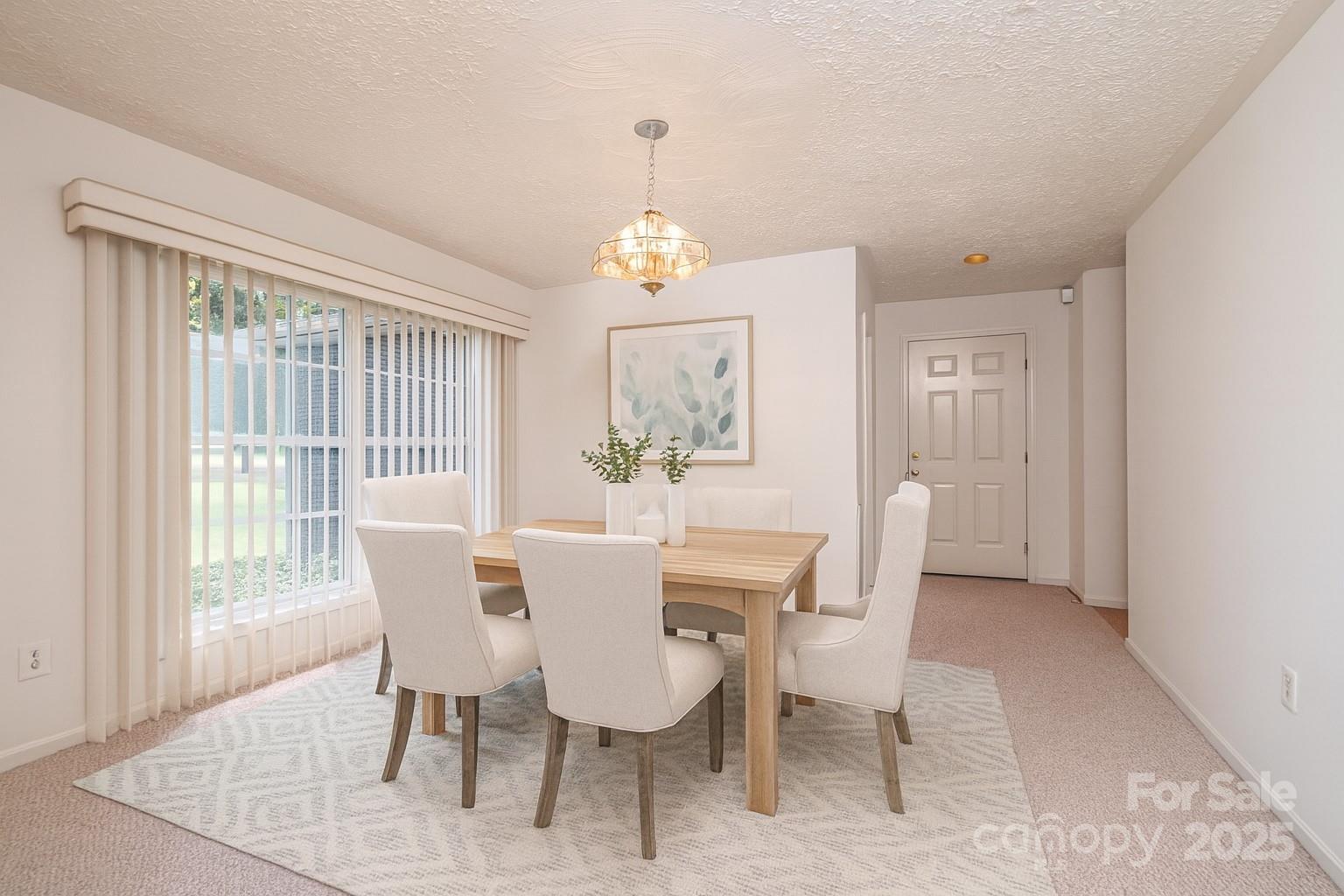227 Robert Keever Road Stanley, NC 28164 - Photo 11 of 45 a view of a dining room with furniture a chandelier and wooden floor