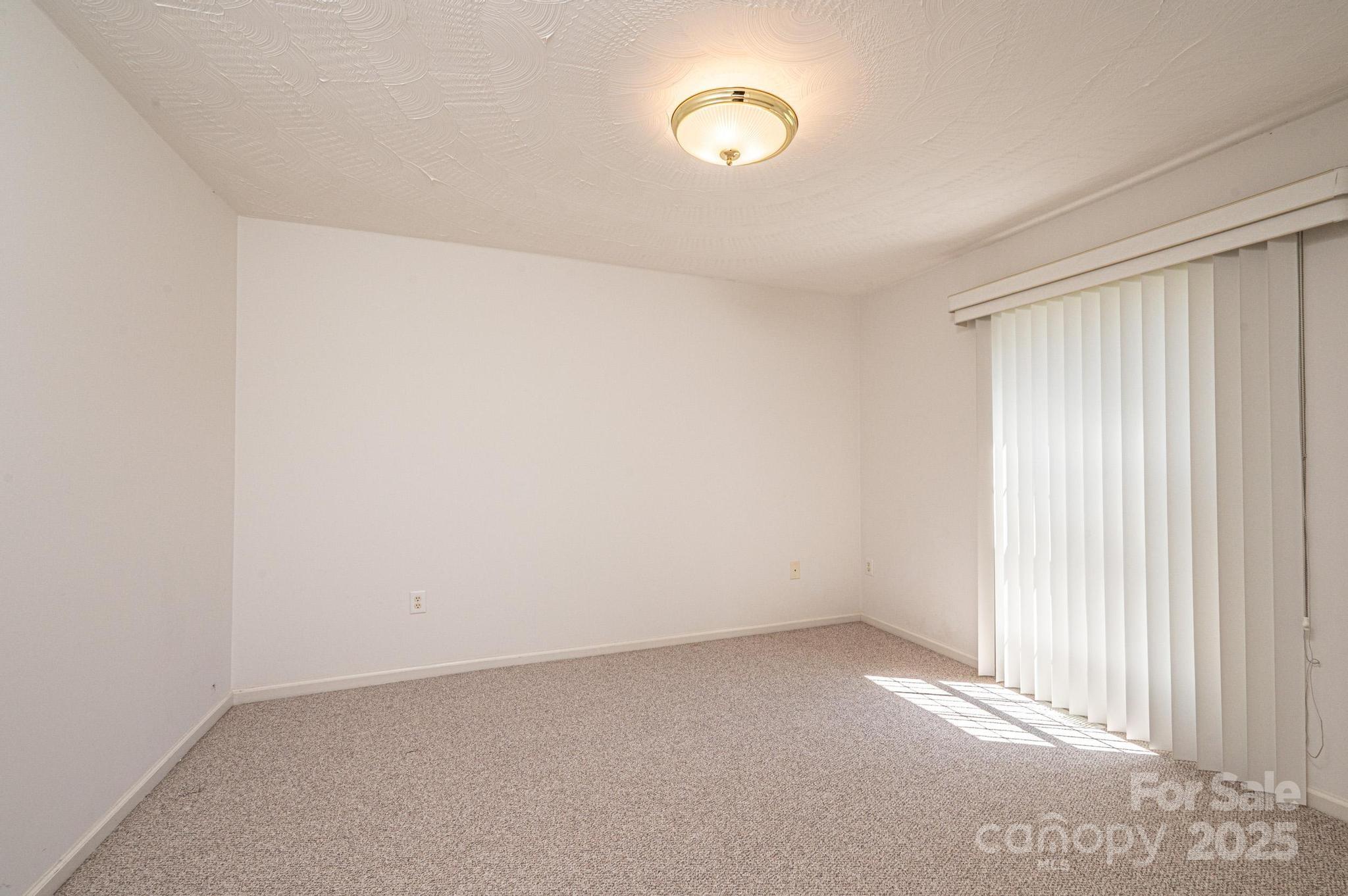 227 Robert Keever Road Stanley, NC 28164 - Photo 14 of 45 an empty room with a empty space and a window
